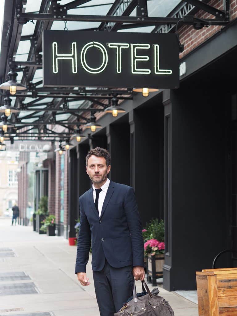 man standing in front of hotel